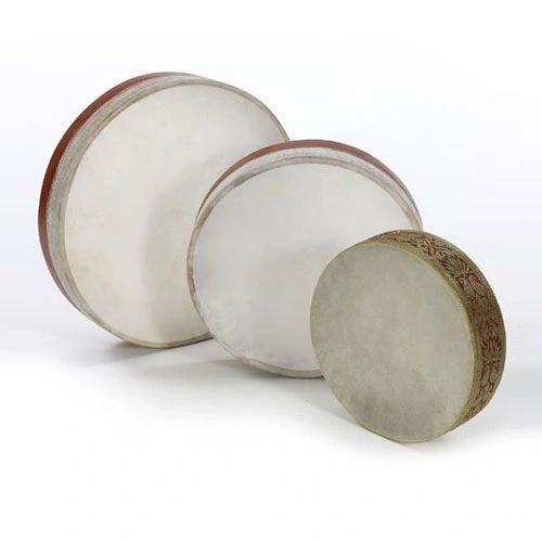 Three frame drums, called daff, with white skins, on a white background.
