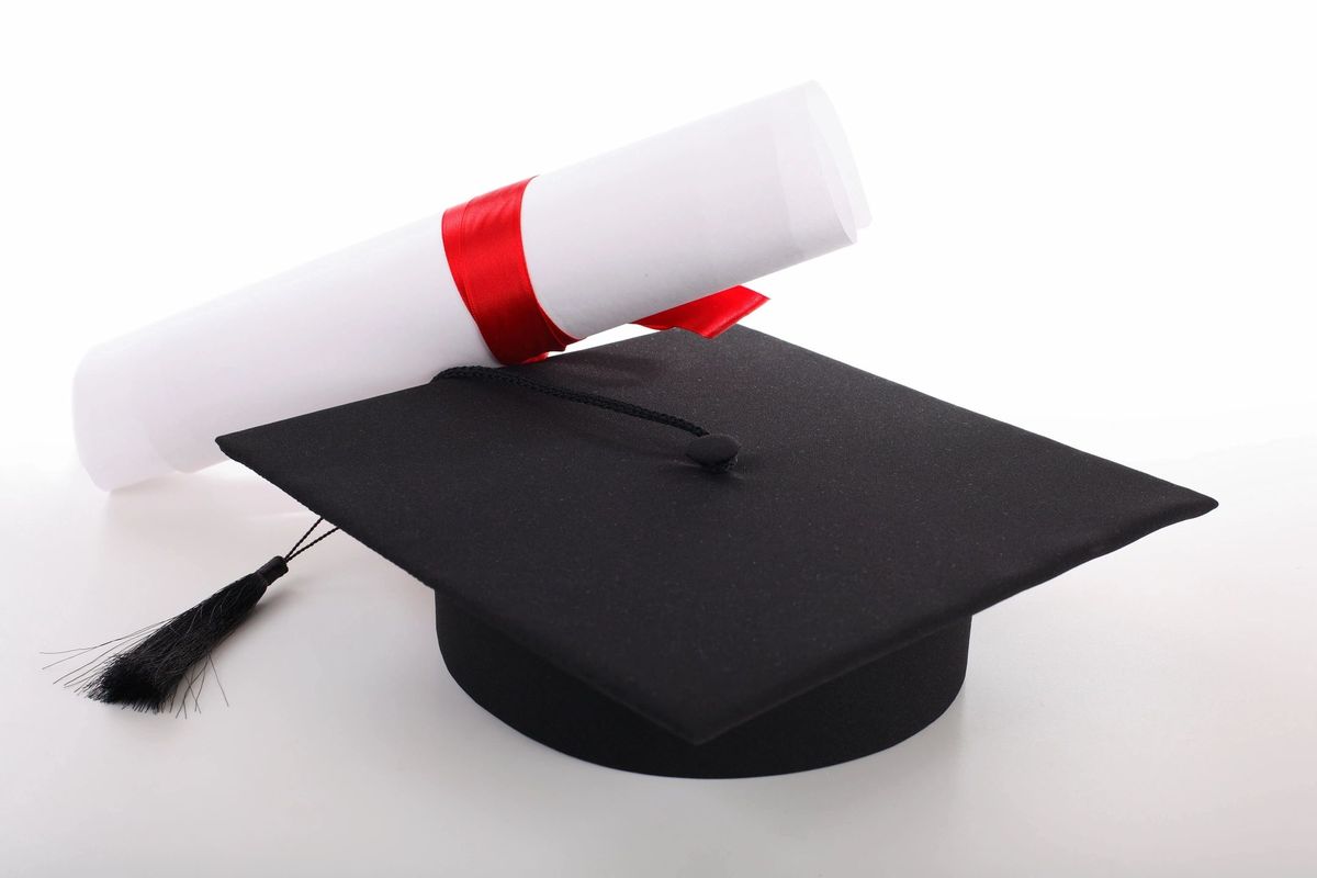 A black graduation cap with a rolled certificate tied in a red ribbon, on a white background.